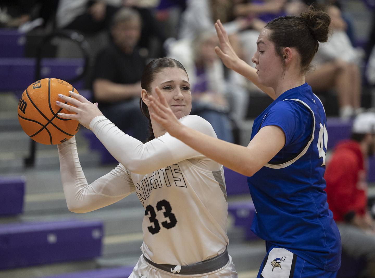 Kaneland’s Kalie Brown looks to pass while being guarded by Geneva’s Adelyn Estabrook  Monday, Feb. 16, 2026, in the Class 3A regional semifinals.