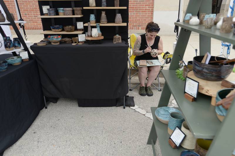 Jenna Bansbach of Elk Grove Village works on a Halloween decoration while selling her work at the La Grange Craft Fair Saturday July 12, 2025.
