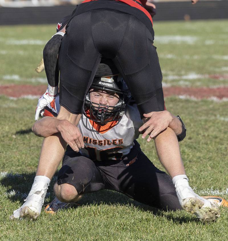 Milledgeville’s Caleb Barber gets low to tackle Amboy’s Colt McCoy Saturday, Nov. 15, 2025, in the 8-man football semifinal.