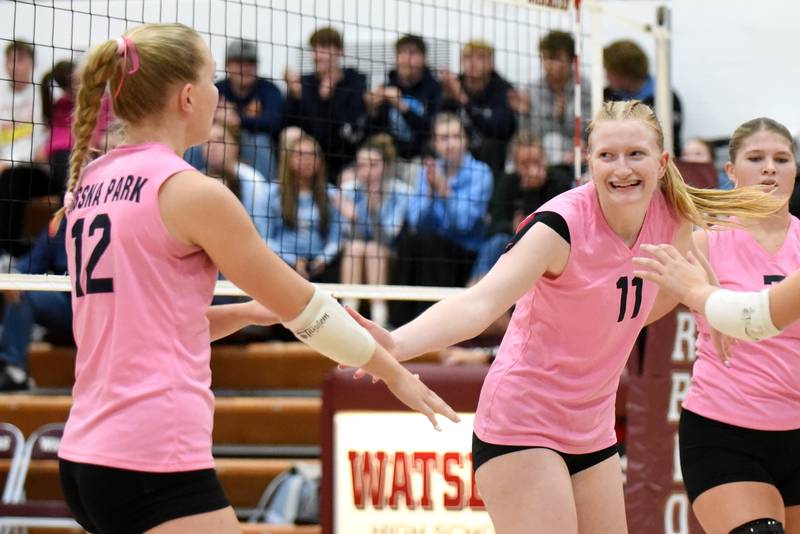 Cissna Park's Sophie Duis (11) celebrates a point with Timberwolves teammate Josie Neukomm (12) during a game at Watseka Tuesday, Oct. 21, 2025.