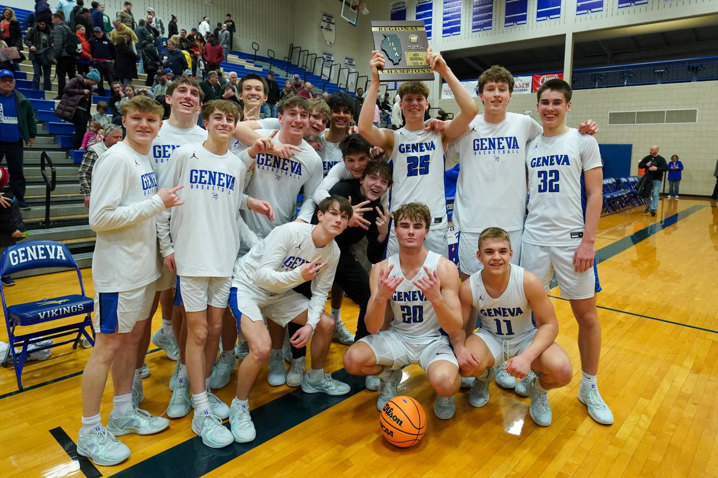 Geneva players pose for photos after defeating Glenbard North to win a class 4A Geneva Regional final basketball game at Geneva High School on Friday, Feb. 28, 2025.
