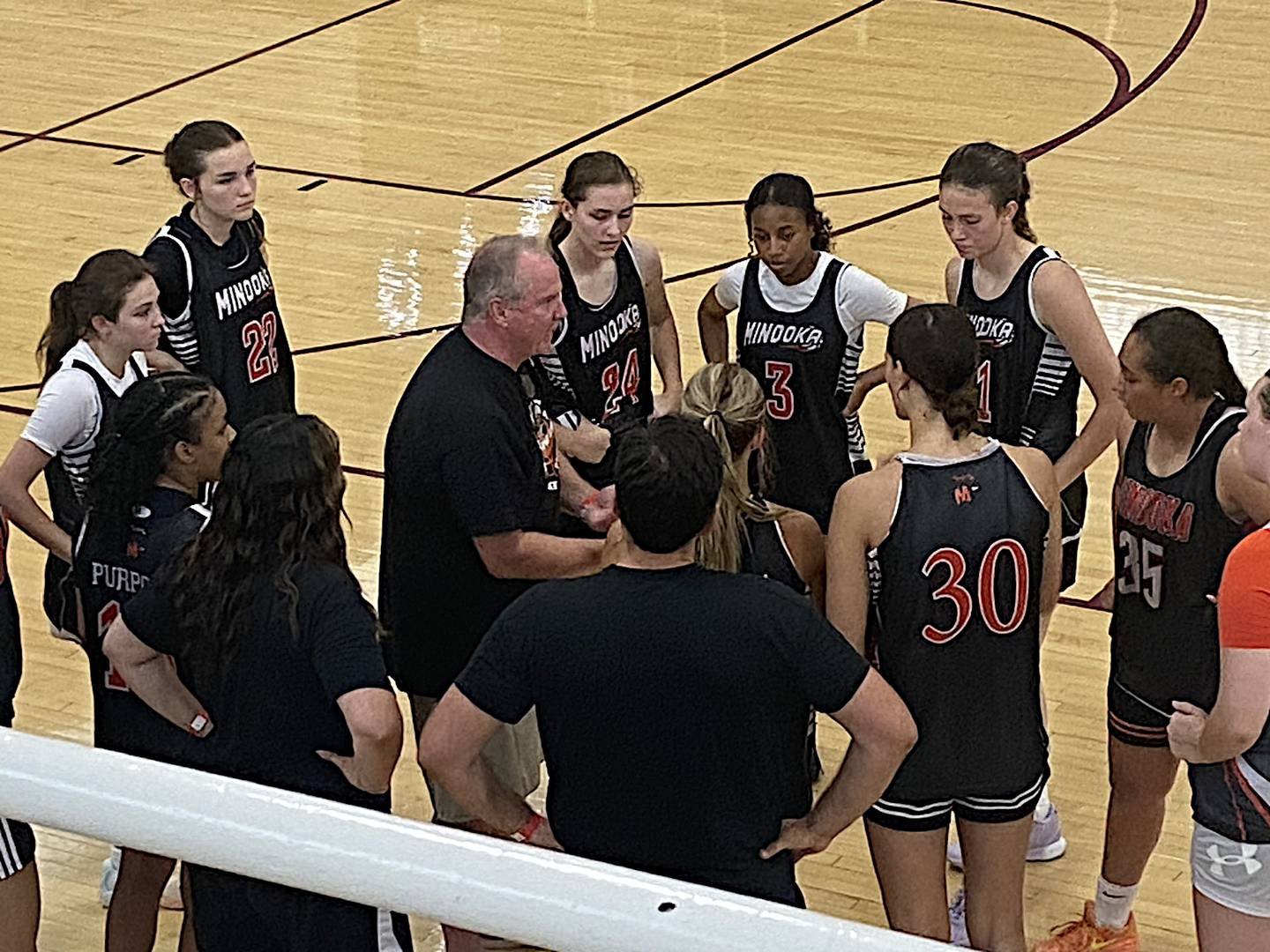 First-year Minooka coach John Placher talks to his team during the 2024 Morris Ladies Shootout.