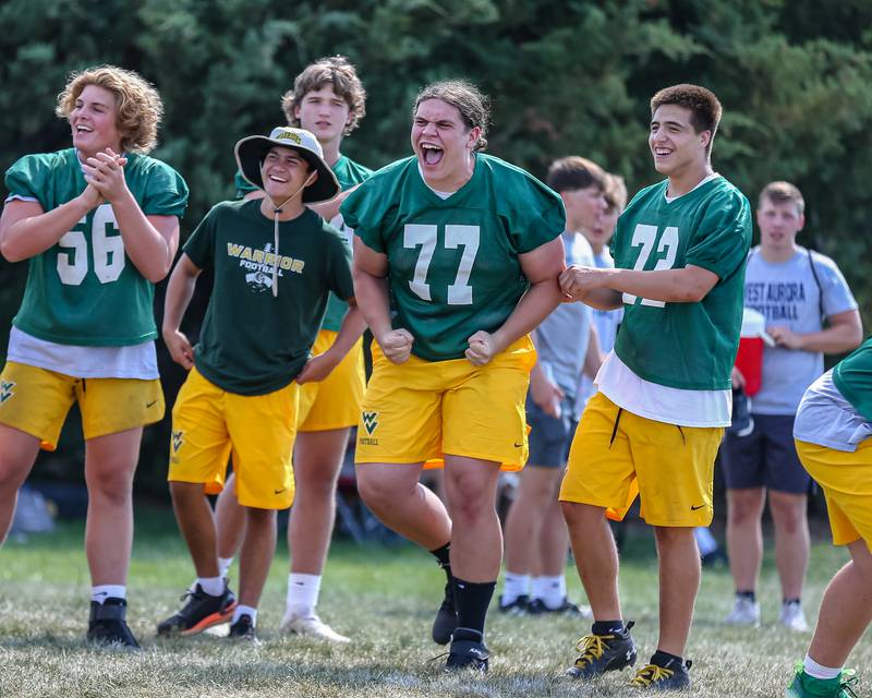 Waubonse Valley lineman cheers on one of their teammates at the West Aurora High School Battle of the Big Butts Linemen Challenge.  July 14, 2022.