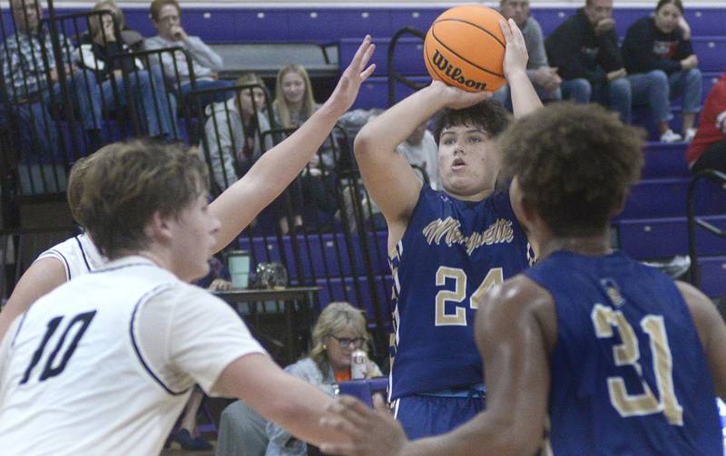 Marquette’s Matt Graham takes a shot from the outside over the blocks of Erie/Prophetstown defense in the 4th period Monday at the Serena Huskers Hardwood Tip-Off Tournament.
