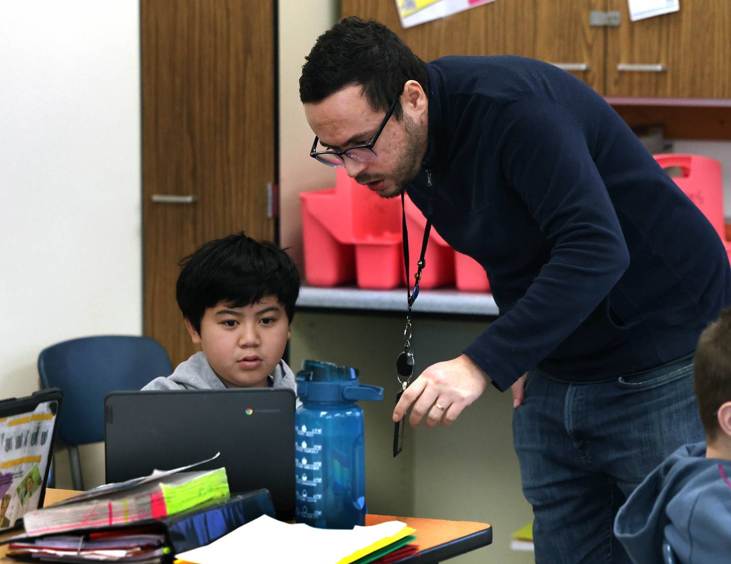 Caio Gomes, a seventh grade teacher from Brazil, helps student Kevin Nguyen Monday, Feb. 2, 2026, during his class at Clinton Rosette Middle School in DeKalb.