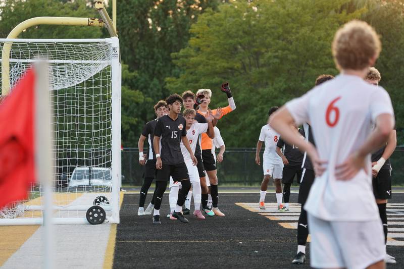 Players from both Wheaton Warrenville South and Oswego fight for position in front of the net before a free kick by Oswego’s Shawn Stogentin (6) during a soccer match at Wheaton Warrenville South in Wheaton on Thursday, Aug 28, 2025.