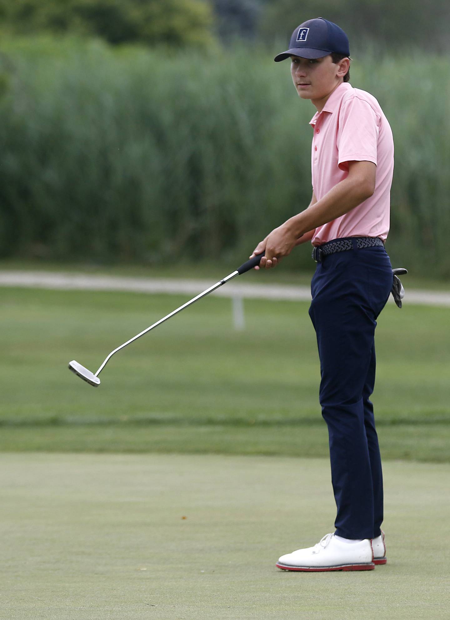 Marian Central’s Peter Louise watches his putt on the ninth green of the Prairie course Wednesday, July 12, 2023, during the second round of the the McHenry County Junior Golf Association's McHenry County Junior Amateur tournament at Boone Creek Golf Club, in Bull Valley.