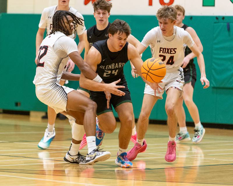 Glenbard West's Brady Johnson goes for the loose ball with Yorkville's Braydon Porter on Friday Dec. 26,2025 at the 51st. Annual Jack Tosh Holiday Tournament in Elmhurst.
