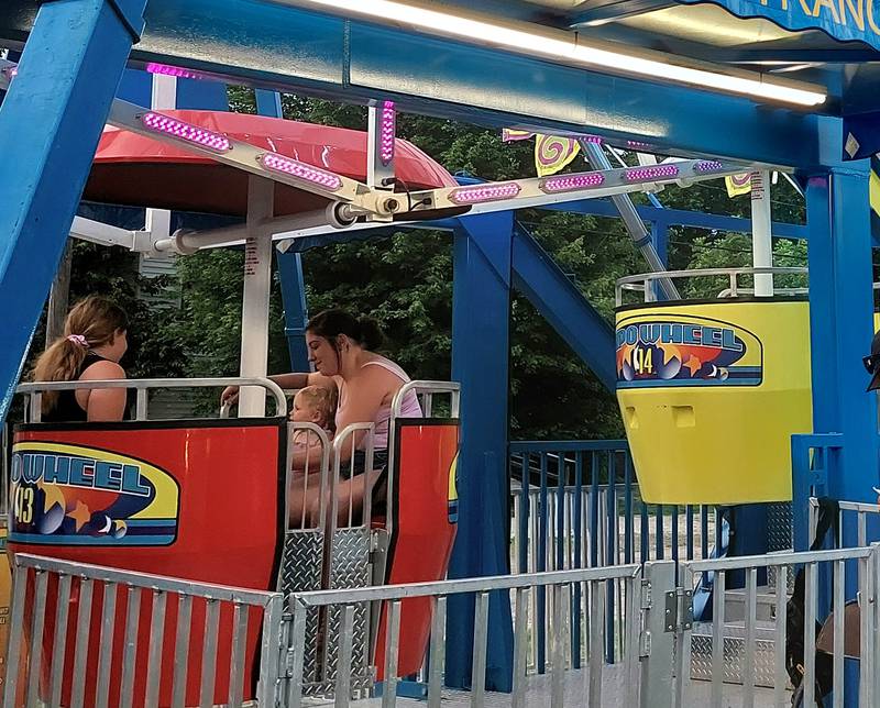 (From left) Beatrice Smith, of Kewanee, joins Ashley Eberson, of Wyanet, and Willow Frank on the Ferris wheel Thursday, June 27, 2024, at the Sheffield Summer Fest.