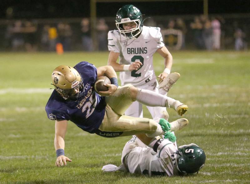 Marquette's Jaxsen Higgins falls to the turf as he is hit by St. Bede's Chase Riva as teammate Carson Riva watches on Friday, Sept. 26, 2025 at Gould Stadium in Ottawa.