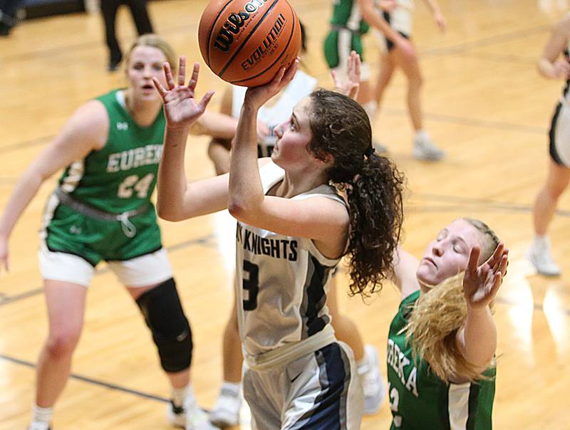 Fieldcrest's Macy Gochanour drives to the hoop to score over Eureka's Sophia Musselman on Monday, Jan. 9, 2023 at Fieldcrest High School.