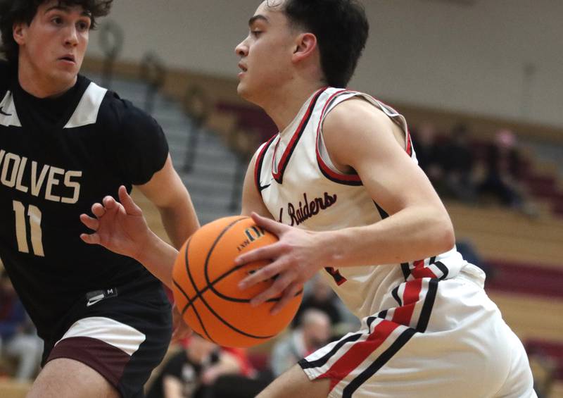 Huntley’s Christian Wilson charges as Prairie Ridge’s Ben Gablenz defends in varsity boys basketball on Tuesday, Feb. 18, 2025, at  Huntley High School in Huntley.