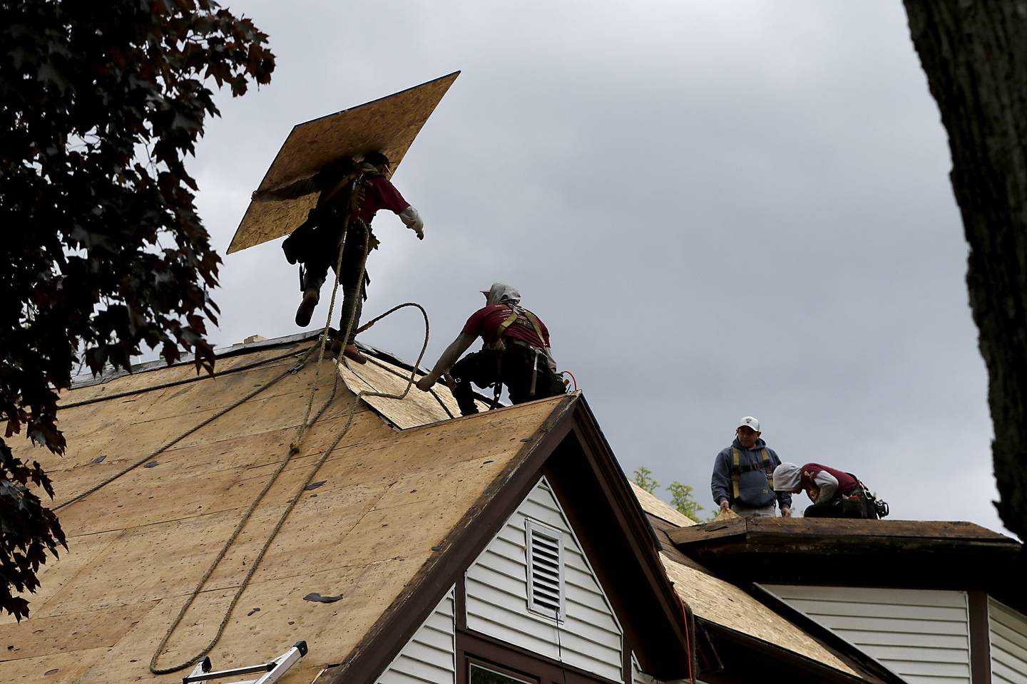 Workers from Innovative Home Concepts replace the roof on U.S Marine Corps veteran Mark McClaughry's home in McHenry on Thursday, May 22, 2025, as part of the “30 Days for 30 Vets” initiative.  The project is a collaboration between The Bremer Team of Keller Williams Success and Innovative Home Concepts.