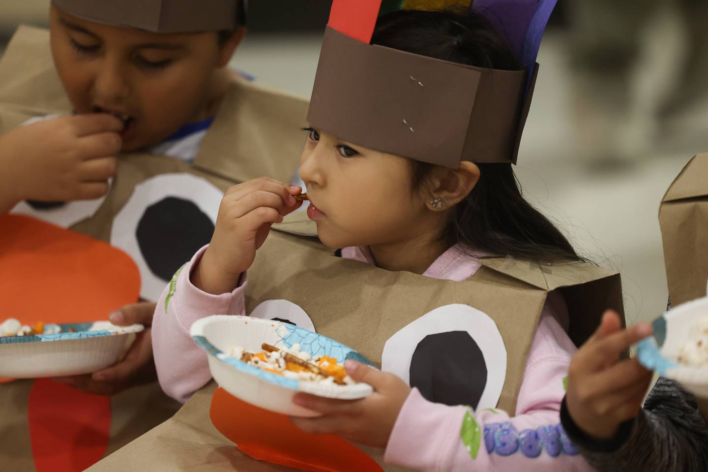 Kindergartener Lizeth Zuluaga enjoys her treats during a Thanksgiving gathering at Thomas Jefferson Elementary School in Joliet on Friday.