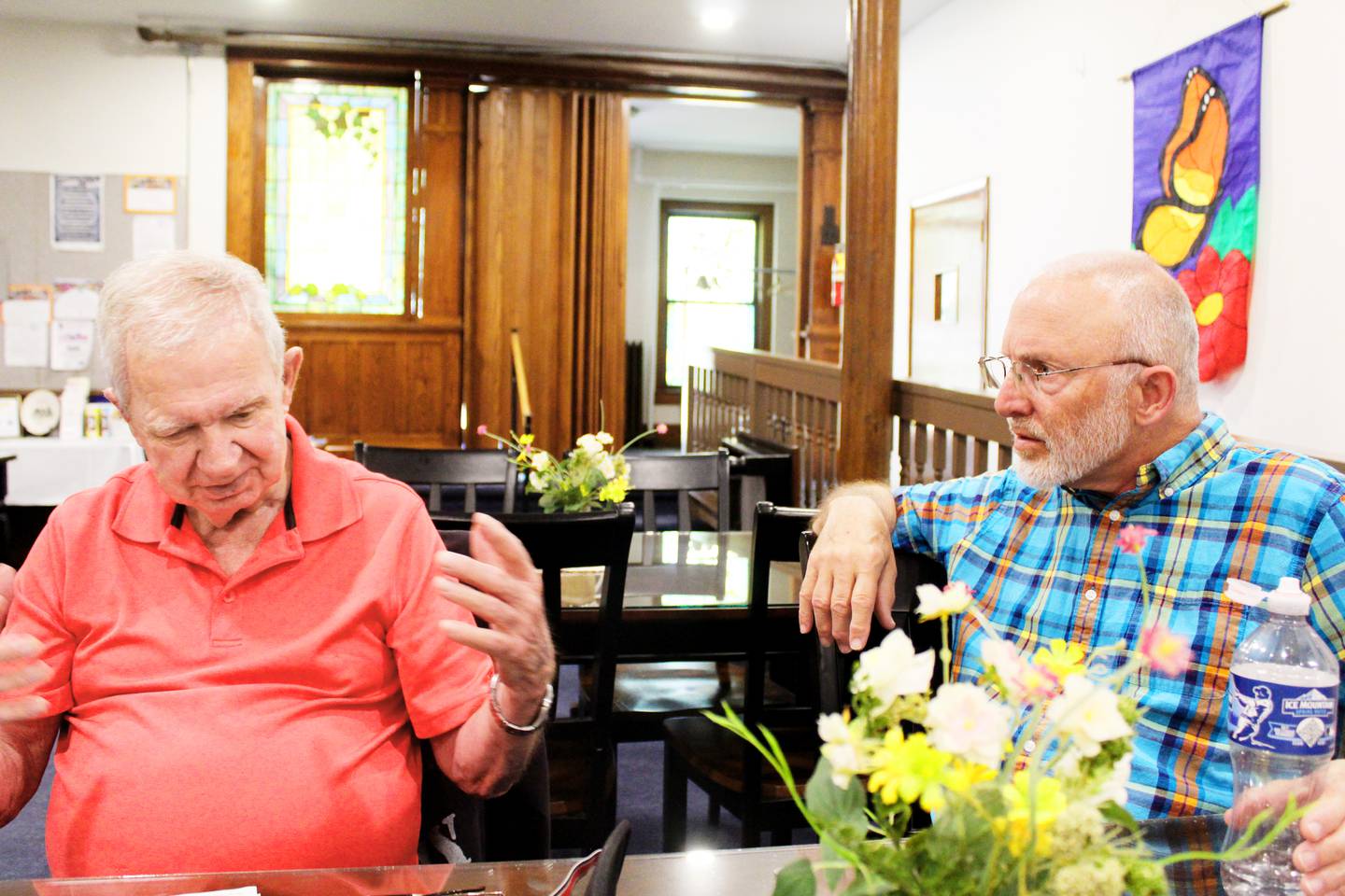 Longtime First United Methodist Church member Ken Heerdt (left) and pastor Brad Wilson share a story about the church, May 23, 2025, in Sterling. Heerdt has been a member since the early 1970s; Wilson has been pastor since 2015.