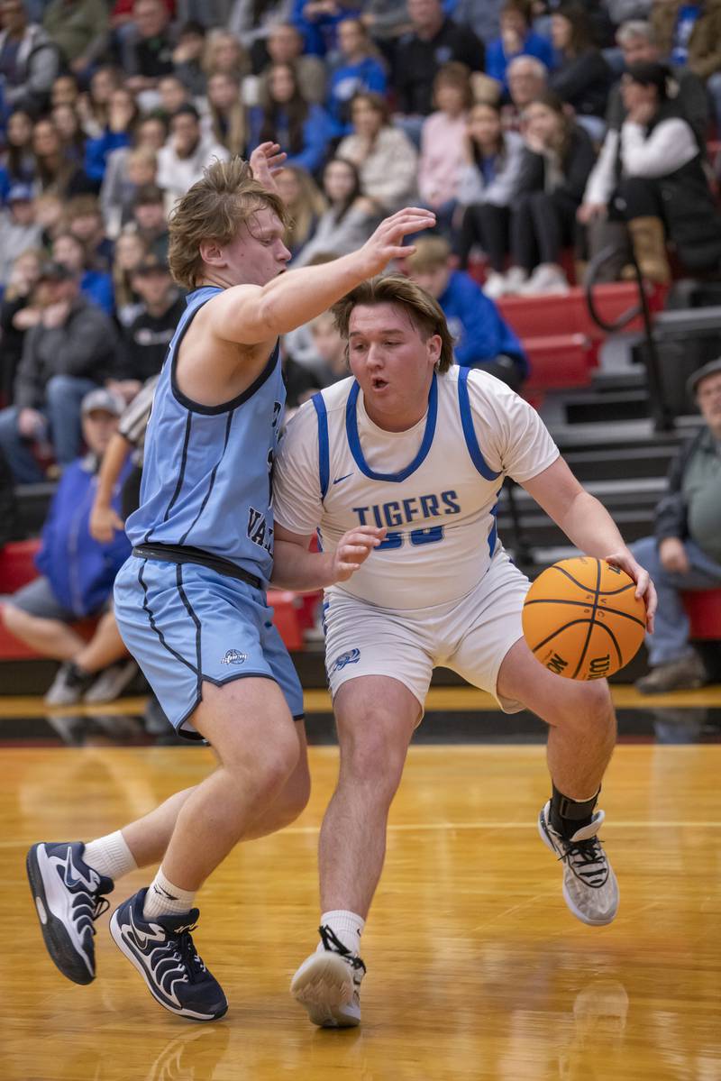 Jordan Reinhardt of Princeton High School tries to gain ground to the basket against a Bureau Valley defender during the Colmone Classic on December 7, 2024 at Hall High School.
