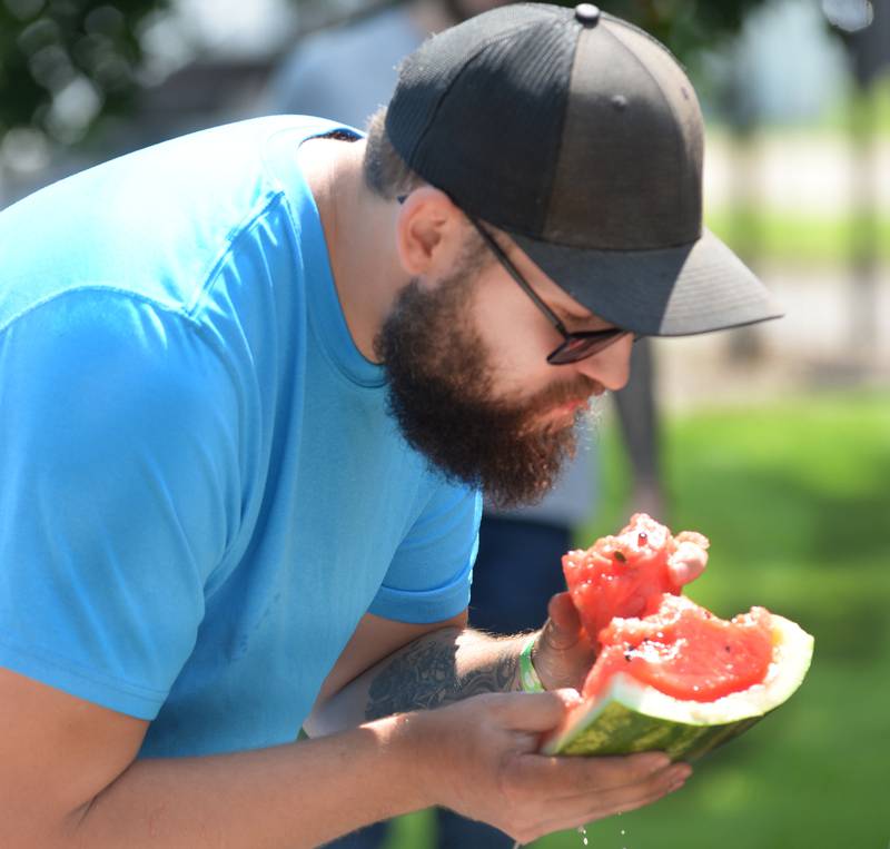 Matt Fraley of Polo gulps down bites of watermelon as he competes in the adult division at Sauerkraut Days' watermelon-eating contest in Forreston on Saturday, Aug. 2, 2025.