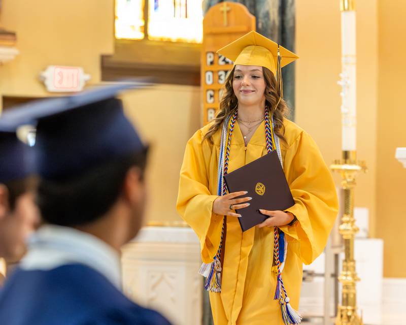 2026 Marquette Academy Graduate and Valedictorian Ava Offermann walks back to seat at the Graduation Ceremony on May 24, 2026 at St. Columba Church in Ottawa.