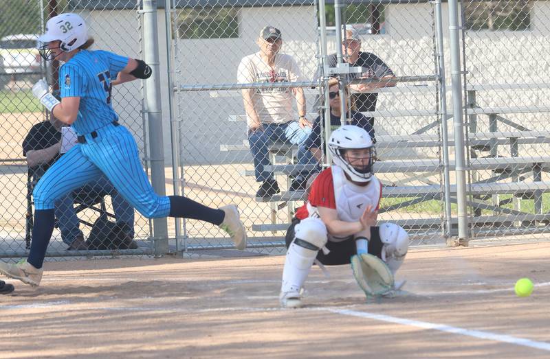 Marquette's Kelsey Cuchra scores a run as the ball arrives late to Henry-Senachwine catcher Addison Robbins on Thursday, April 23, 2026 at June Cross Field in Ottawa.