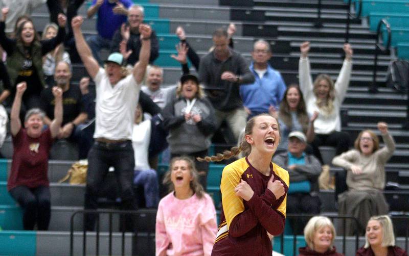Richmond-Burton’s Lillian Mumbower celebrates a win in varsity volleyball at Woodstock North Monday night.