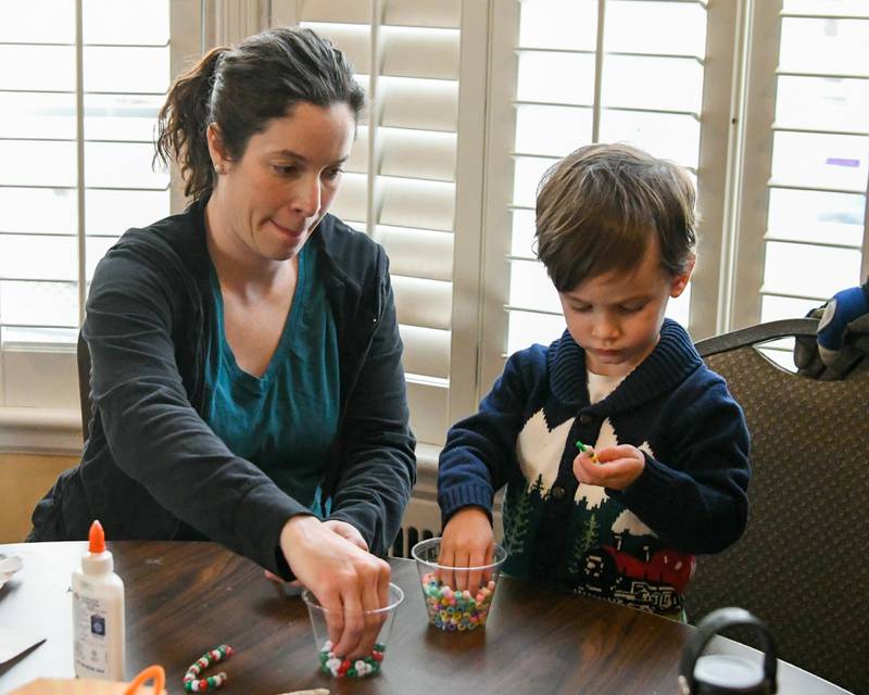 Noel Libman and her son Arlo, 2, of West Dundee work on some crafts during the Polar-Palooza Saturday Jan. 17, 2026, at Creek Bend Nature Center in St. Charles.