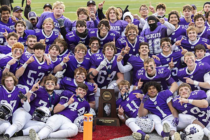 The Wilmington Wildcats celebrate their 28-3 win over Athens Friday, Nov. 24, 2023 in the 2A state football championship game at Hancock Stadium in Normal.