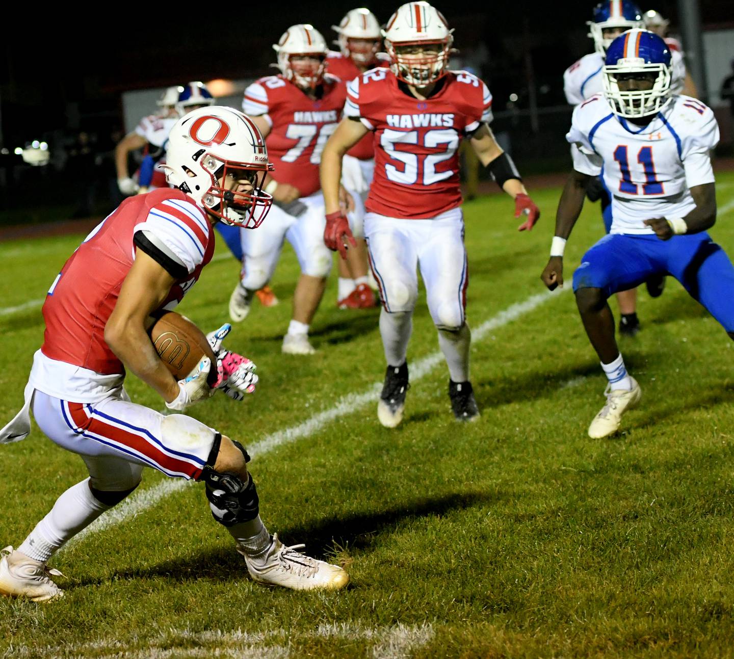 Oregon's Austin Egyed catches a pass and looks to avoid Genoa-Kingston tacklers during Sept. 30 action at Landers-Loomis Field.