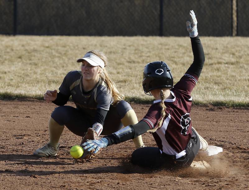 Grayslake North’s Isabella Lizano tries to field the throw to second base as Prairie Ridge’s Adysen Kiddy safety slides into the base during a nonconference softball game Thursday. March 23, 2023, at Grayslake North High School.