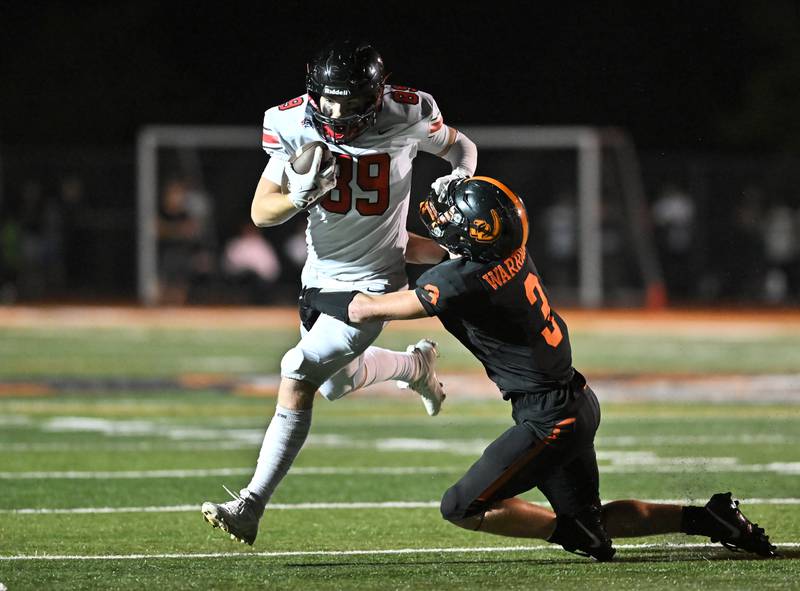 Lincoln-Way Central's Ryan Studenroth (89) ties to stiff ar Lincoln-Way West's Chase Markowicz (3) during the conference game on Friday, SEP. 19, 2025, at New Lenox.