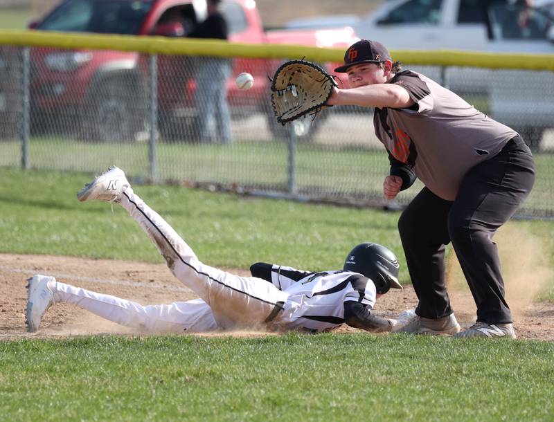 Sycamore's Jack Montani dives back safely into first as Freeport's Chace Krzeminski catches the ball Tuesday, April 7, 2026, during their game at the Sycamore Community Sports Complex.