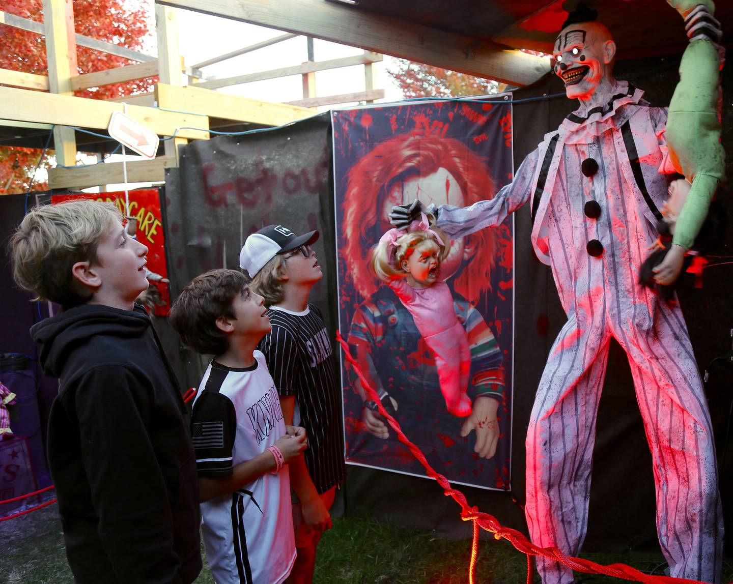 (Left to right) Mason Schnurstein, Cole Santagata and Ryan Johnson see a frightening clown at the Kamme-O-Circus Halloween Haunted House on Saturday, Oct. 19, 2024 in Elburn.