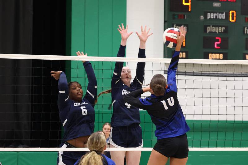 Grace Christian's Sarah Rauwolf, center, and Miranda Glenn, left, jump to block a hit by Clifton Central's Ellie Perzee during Grace Christian's victory in two sets, 25-20, 25-16, in the IHSA Class 1A Dwight Regional quarterfinals on Monday, Oct. 27, 2025.