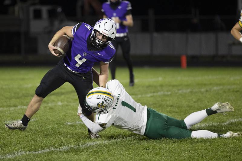 Dixon’s Landon Knigge fights off a tackle by Coal City’s Brock Finch Friday, Nov. 7, 2025.