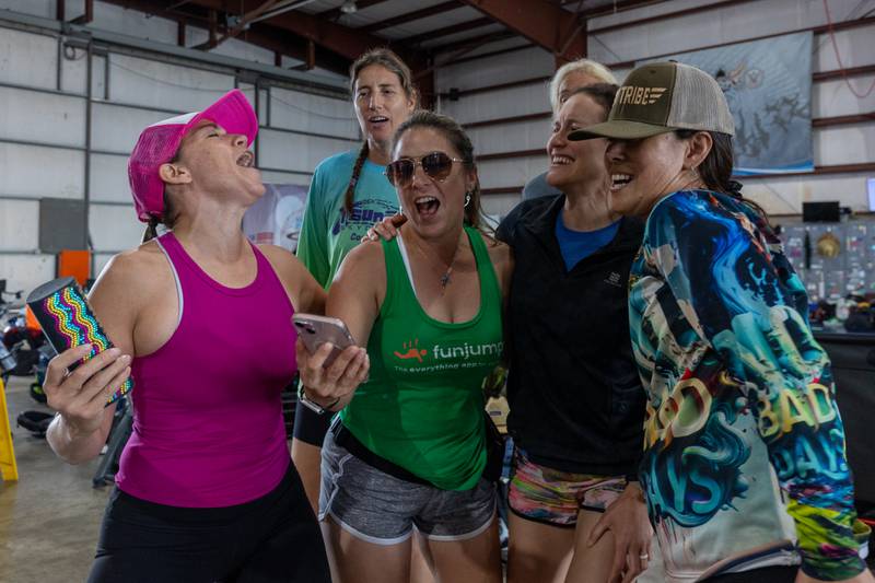 International divers sing and dance whilst waiting for weather delay to be lifted on Wednesday, Aug 20, 2025 at Skydive Chicago in Ottawa.