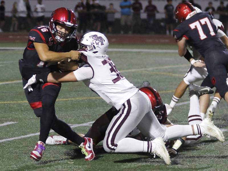Huntley's Braylon Bower is tackled in the backfield by Prairie Ridge's Giovanni Creatore during a Fox Valley Conference  football game on Friday, Sept. 20, 2024, at Huntley High School.