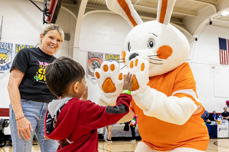 Joel Castro high-fives “Wiley the bunny” on Friday, May 2, 2025 at Northbrook School in Mendota.