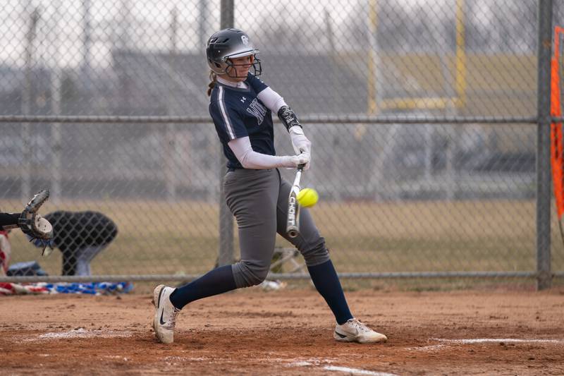 Oswego East's Nicole Stone (16) drives in a run against Metea Valley during a softball game at Metea Valley High School in Aurora on Friday, Mar 24, 2023.