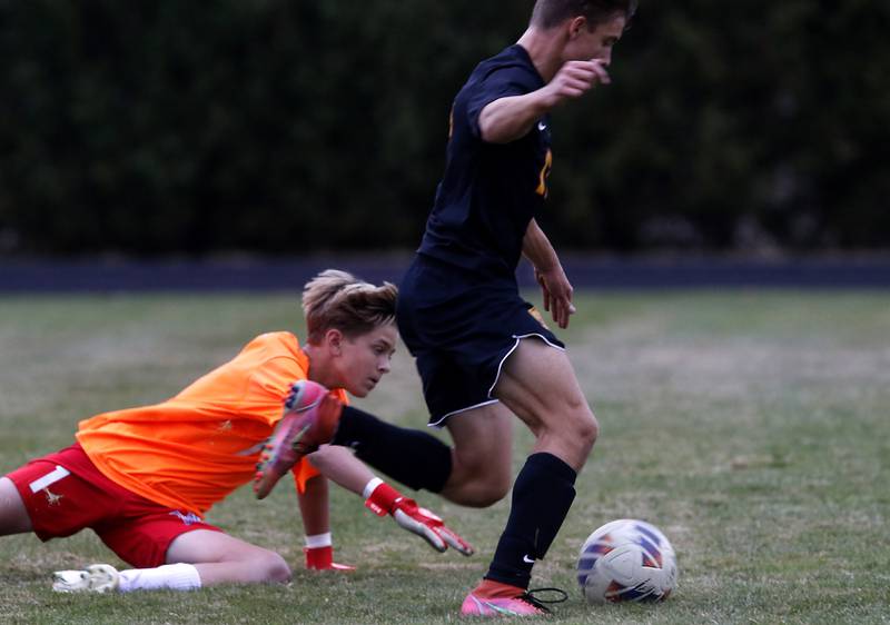 Richmond-Burton's Joseph Kyes beats Marian Central goalkeeper Dustin Emmert  to the ball during the IHSA Class 1A Marian Central Regional Boys Soccer Final match on Tuesday, Oct. 22, 2024, at Marian Central High School in Woodstock.