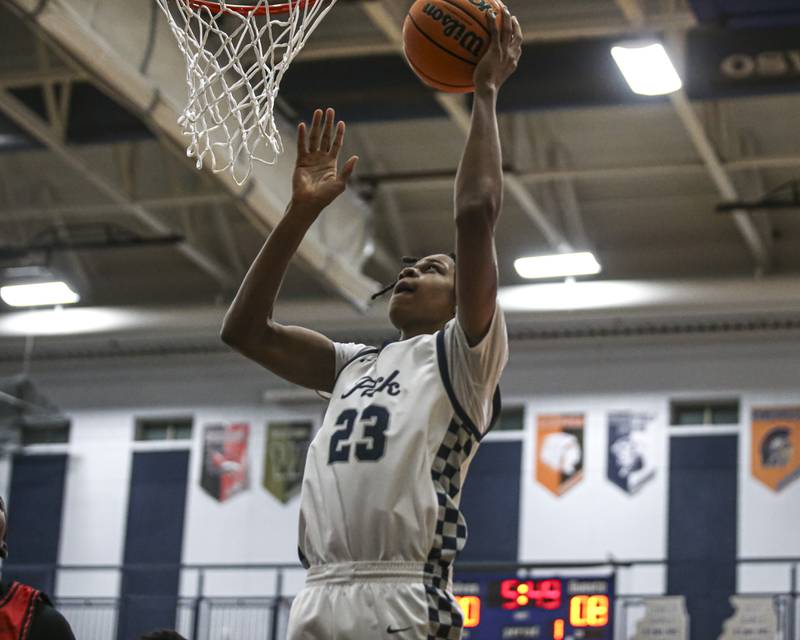 Oswego East's Mason Lockett (23) goes in for a layup during their basketball game between Bolingbrook at Oswego East Friday, Jan 30, 2026 in Oswego.