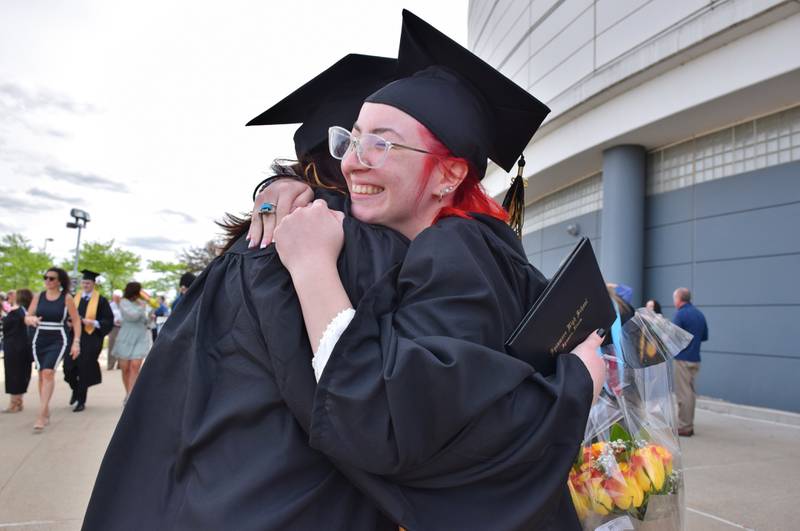 Friends Olivia Byrd, right, and Autumn Tomlinson hug each other after the commencement ceremony of Sycamore High School's Class of 2022, held Sunday, May 22, 2022 at Northern Illinois University's Convocation Center in DeKalb.