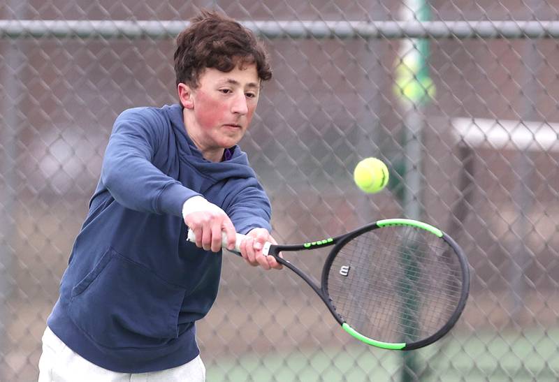 Dixon’s number one singles player Bashar Elbzour follows hits a backhand during his match against Sycamore Thursday, March 30, 2023, at Sycamore High School.