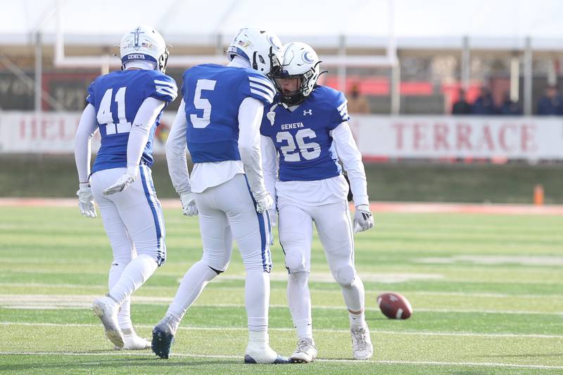 Geneva’s Tate Beran (26) is greeted by teammates after breaking up a pass to force 4th down against East St. Louis in the Class 6A state championship on Saturday, Nov. 30, 2024 in Normal.