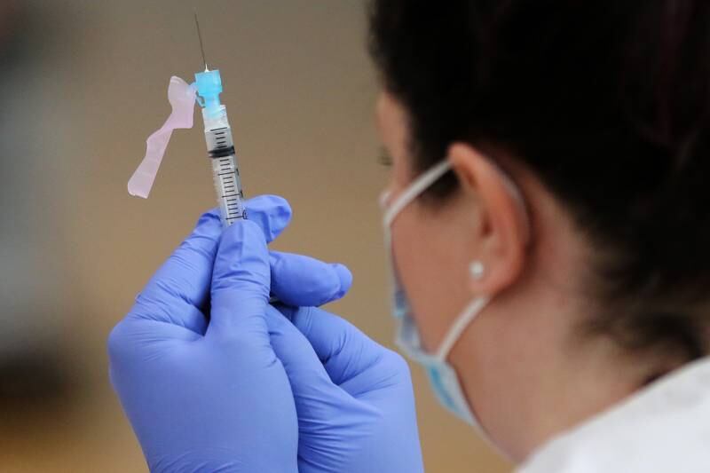 Woodstock Community Unit School District 200 nurse Stacy Spring fills a syringe with the Moderna COVID-19 vaccine during a vaccination clinic for staff with Woodstock Community Unit School District 200 and Johnsburg School District 12 at Woodstock North High School on Thursday, Feb. 11, 2021 in Woodstock.  The clinic is hoping to vaccinate 2,600 employees of school districts in the northern half of McHenry County with the Moderna COVID-19 vaccine over the course of Thursday and Friday.