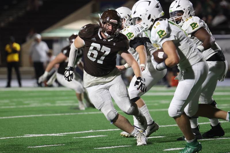 Joliet Catholic’s Mitchell Ragusa locks in on Providence’s Colin Sheehan on Friday, Sept. 1, 2023 Joliet Memorial Stadium.