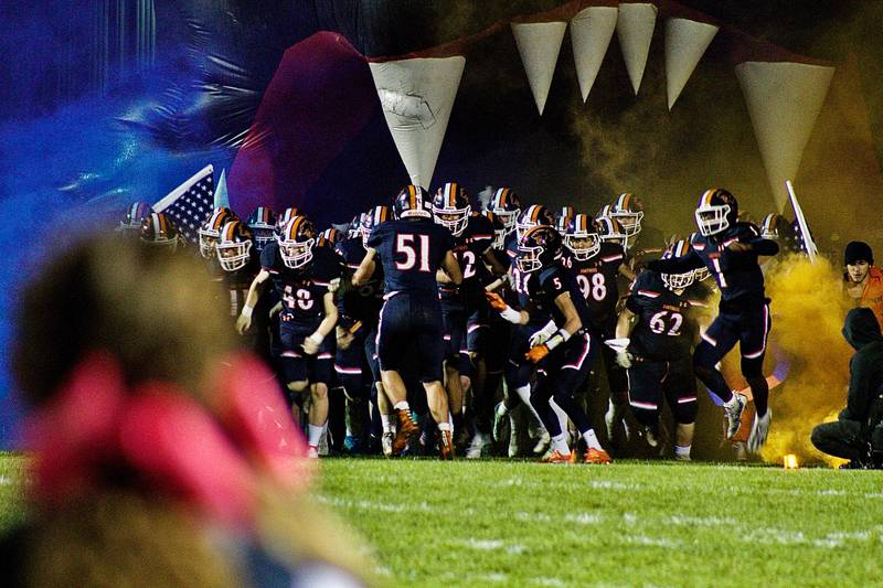 Orange and blue smoke ushered the varsity Oswego High School football team onto Pickerill Stadium for the annual Crosstown Challenge game against Oswego East High School on Oct. 15. OHS took home a 38-14 victory and regained the Crosstown title.