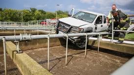 Pickup truck pushed to the edge of wastewater treatment tank following crash Monday in Woodstock
