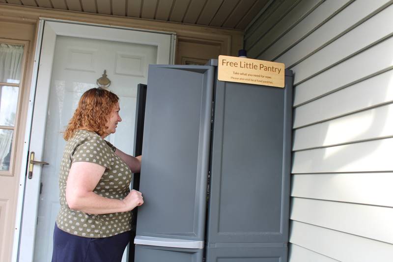 Cary resident Cindy Straeten organizes the latest donations for her free little food pantry on her front porch.