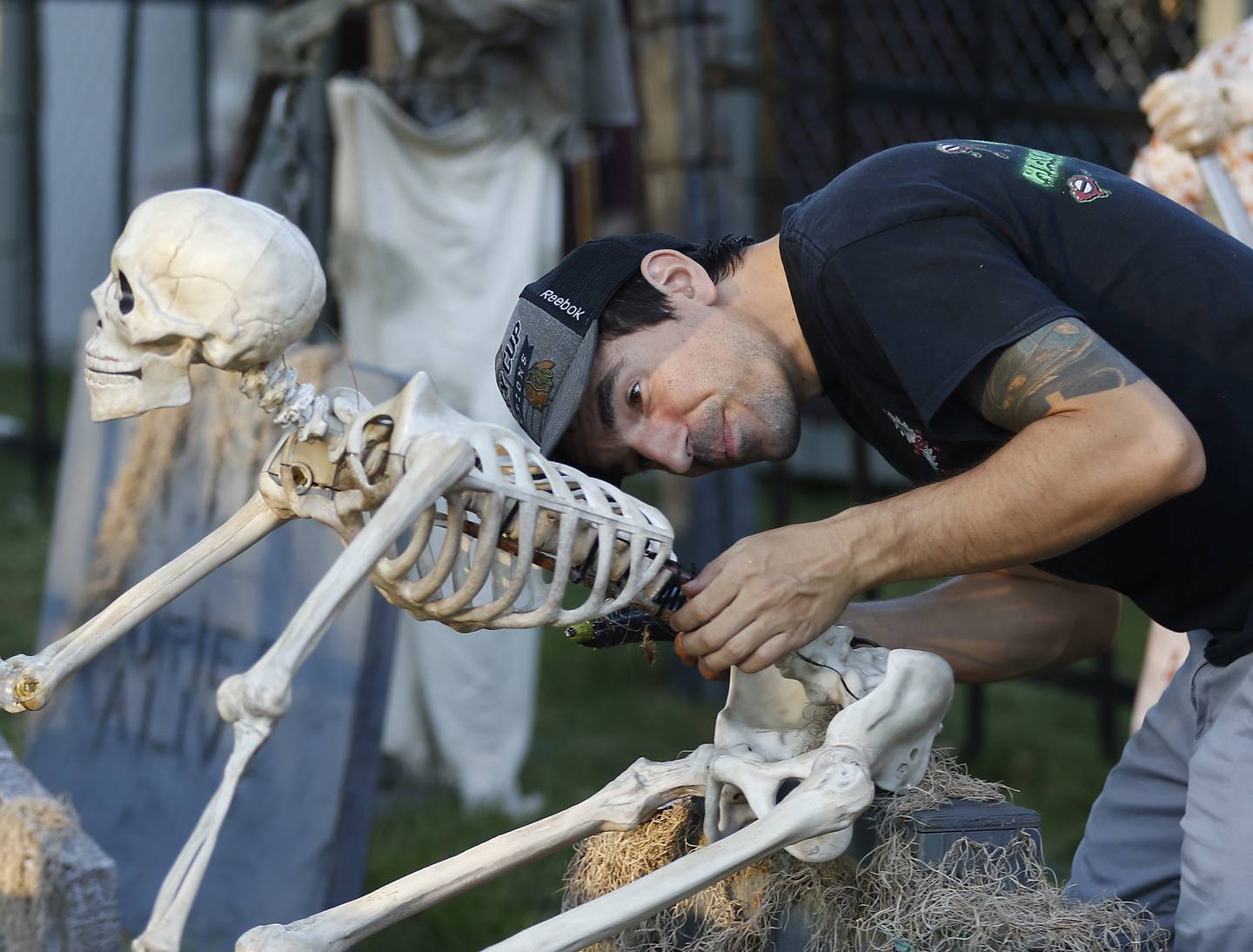 Chris Skaja works on setting up the "Massacre on McKinley" Halloween display at his home, 4 McKinley St. in Lake in the Hills, on Wednesday, Oct. 5, 2022. The display opens to the public on Saturday.