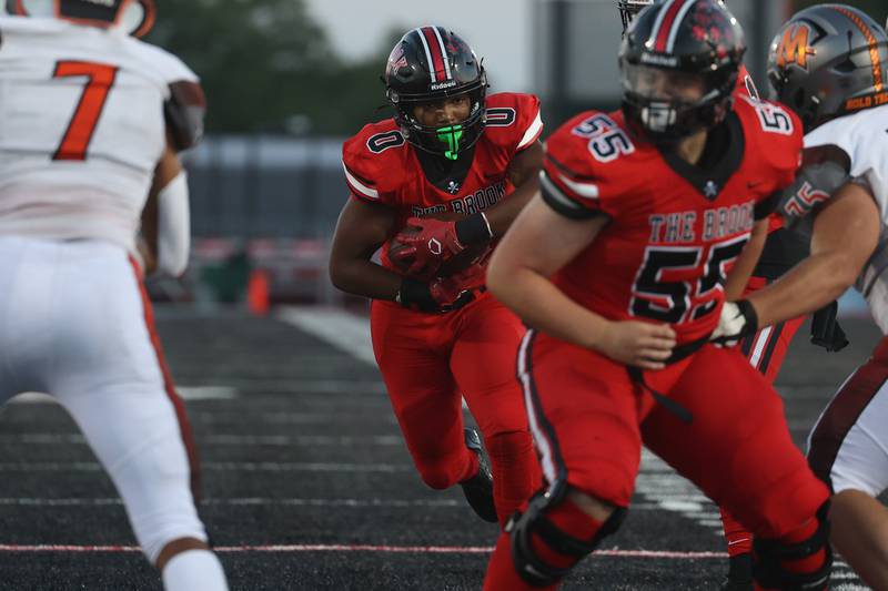Bolingbrook’s Joshua Robinson runs up the middle against Minooka. Friday, Aug. 26, 2022, in Bolingbrook.
