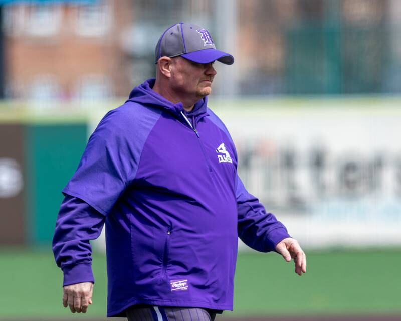 Dixon's head coach Jason Burgess walks to the dugout during baseball game between Dixon at Hampshire.  March 28, 2024